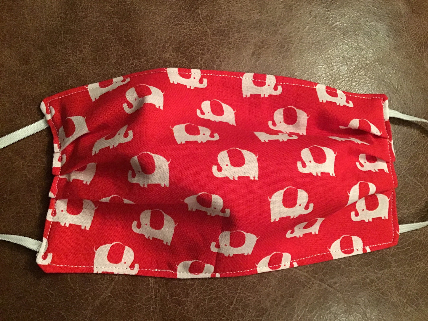 Handmade reversible face mask with elephants on one side and red on the other side