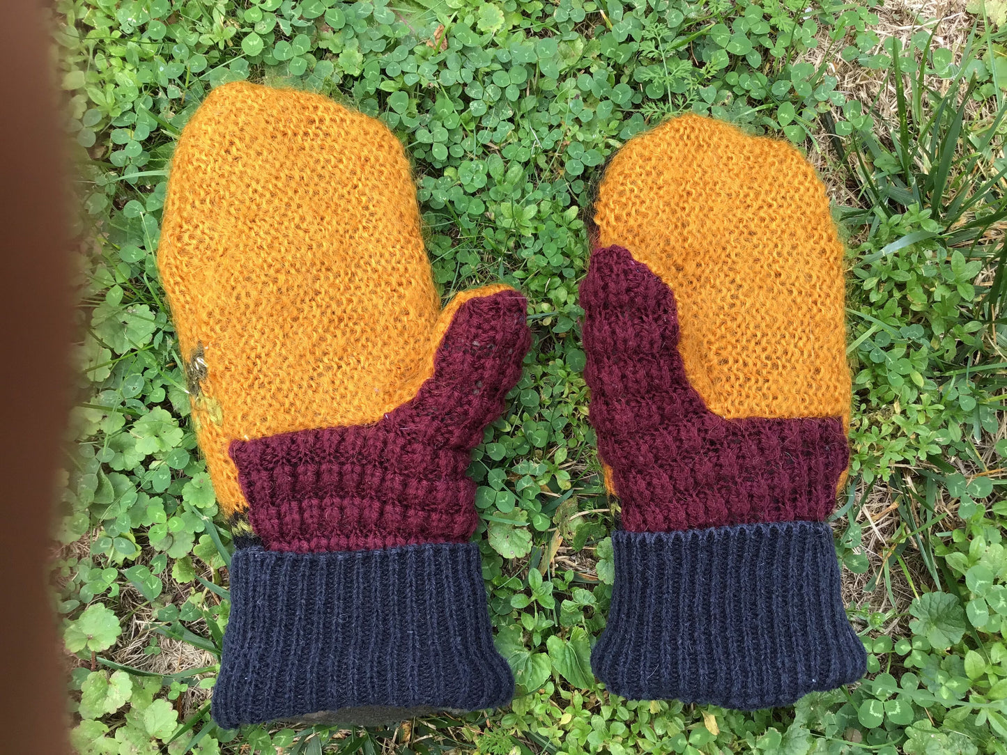 Handmade mittens from recycled sweaters. Multicolor with gold, mauve, black and green. Palm side is gold, black and mauve. Lined with fleece