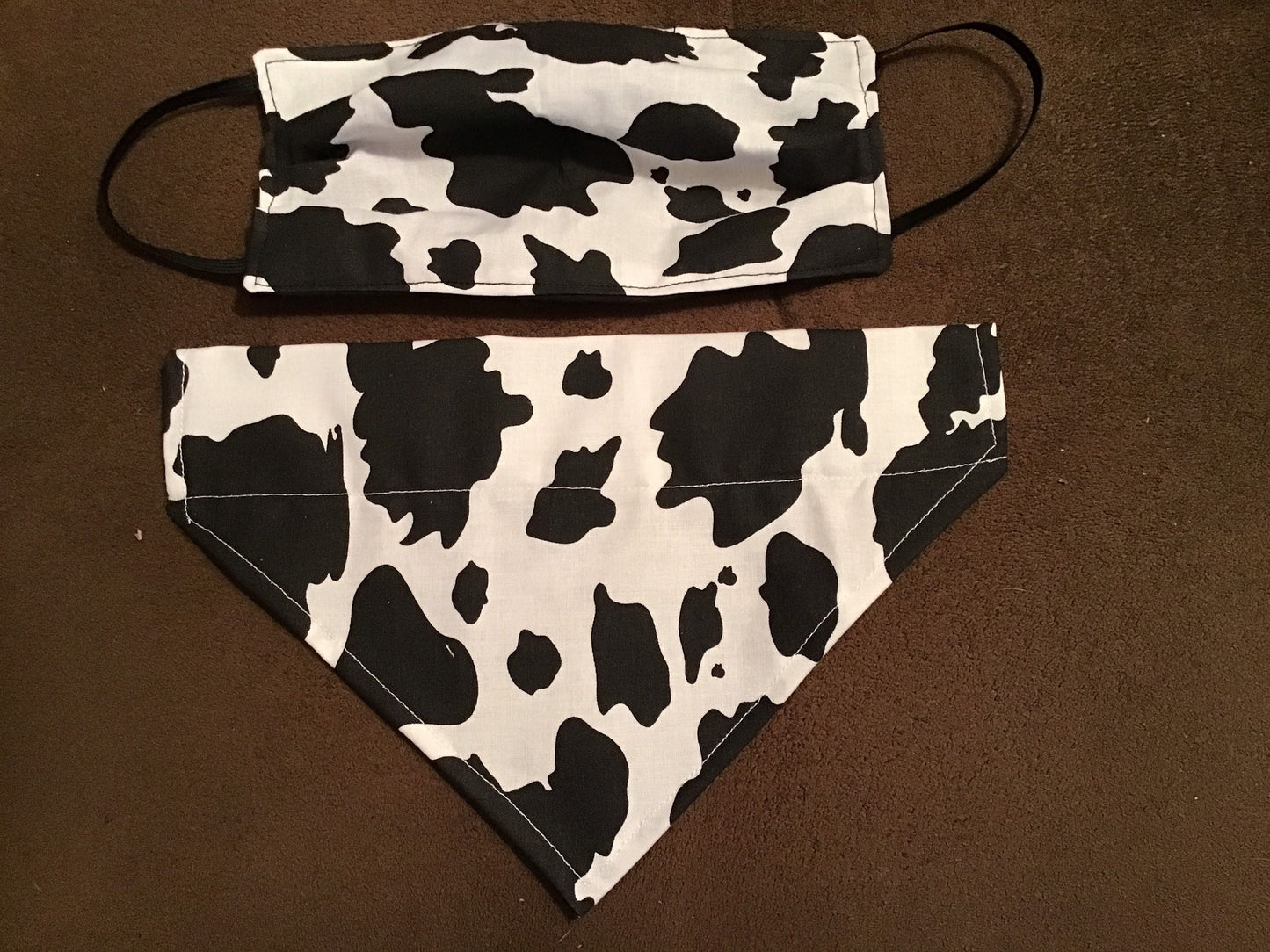 Cow print face mask with matching dog bandanna